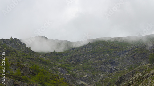 Peak mountains are surrounded by low clouds © Matteo