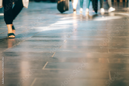 Closeup of peoples legs walking with copy space. Shallow depth of field