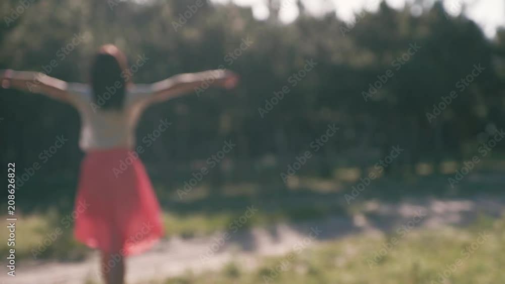 An unfocused silhouette of a young beautiful woman, who puts her hands behind her head An unfocused silhouette of a young beautiful woman, who puts her hands behind her head
