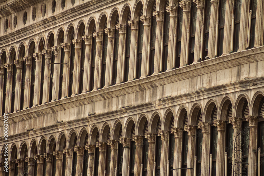 Detail of fronts of Renaissance buildings. Ornate archways in the columns.