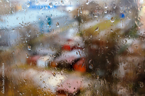 Raindrops on the street window. Bad weather, thunderstorm.