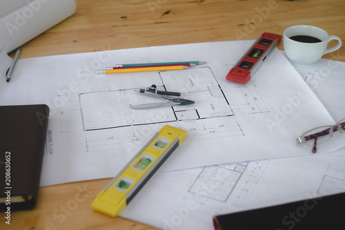 Architectural plans work space top view. Architectural project, blueprints,pencil and divider compass on wooden desk table.Construction background.Engineering tools. Copy space.Architectural Concept