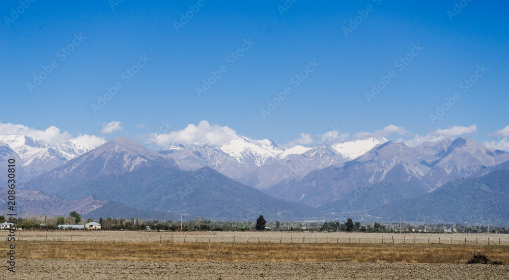 The magic nature, high majestic mountains are covered with white snow under the blue sky The magic nature, high majestic mountains are covered with white snow under the blue sky