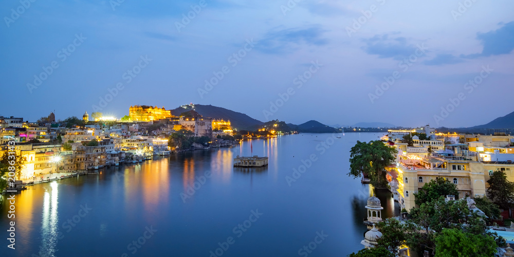 Udaipur city at lake Pichola in the evening, Rajasthan, India. View of City palace reflected on the lake.