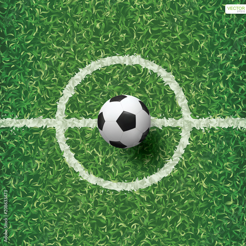 Soccer football ball on green grass of soccer field pattern and texture background with center line area. Vector.