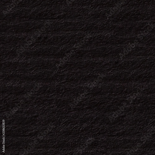 Saturated dark grey paper texture with shades. Seamless square background, tile ready.