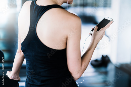 attractive woman relax with smartphone after hard workout in gym sport ideas concept