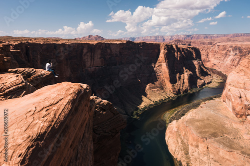 young man on top of mountain with Magnificent view of Grand Canyon, Arizona, USA.