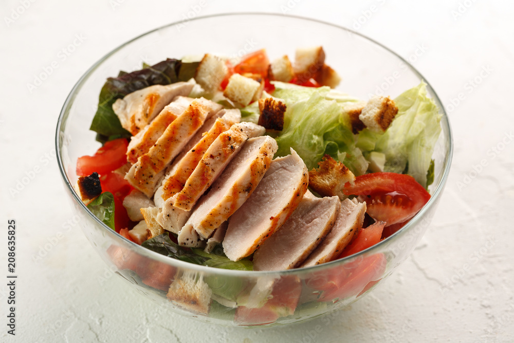 salad cesar with chicken grill in glass bowl on white table. Top view. Flat lay. salad cesar with chicken grill in glass bowl on white table. Top view. Flat lay.