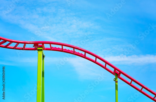 Roller coaster pink tracks in an amusement park.