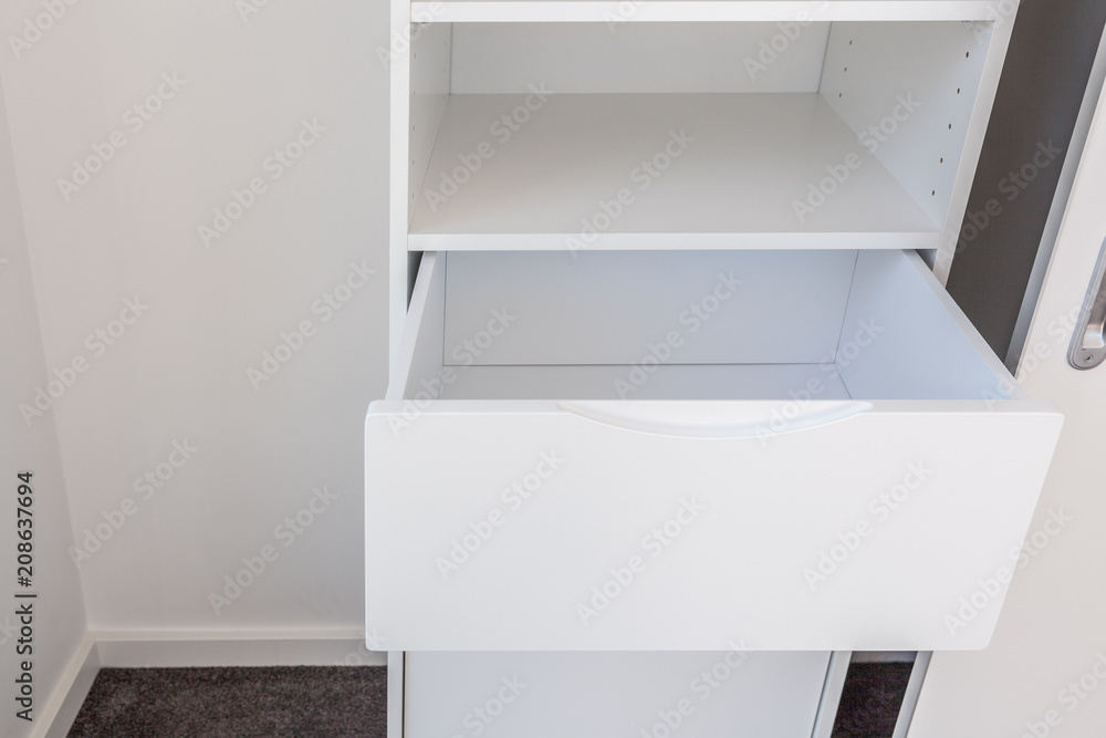 Open drawer in white cupboard Open drawer in white cupboard