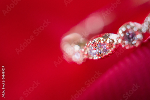 Jewelry luxury pink gold ring with sapphire gemstone on red fabric texture background