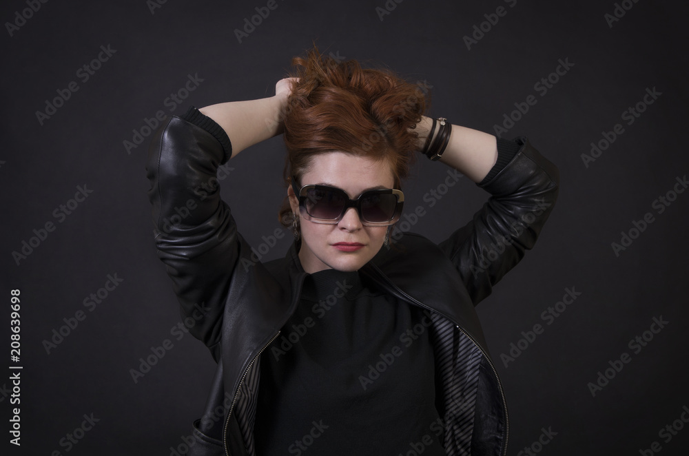 Emotional brunette posing in the Studio in a leather cloak. Emotional brunette posing in the Studio in a leather cloak.