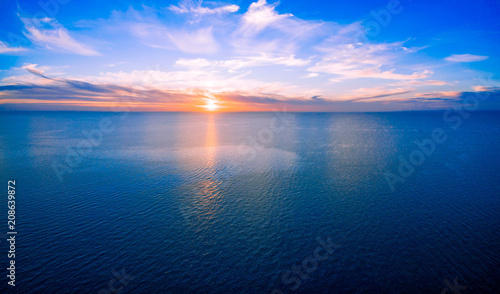Sun setting over ocean - minimalist sunset aerial panorama