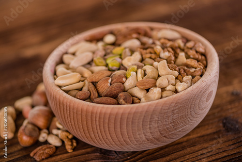 wooden bowl full of different muxture variety of nuts 