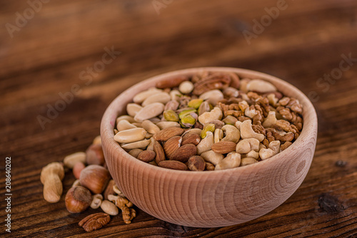 wooden bowl full of different muxture variety of nuts 