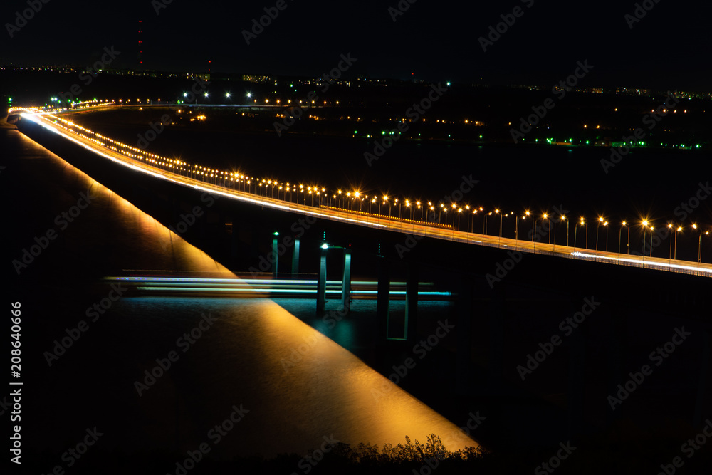 Long bridge in night with cars light. President bridge on the Volga River, Ulyanovsk.