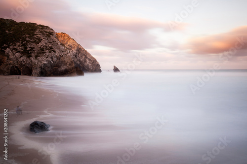 Rocky coastline of Adraga beach sunrise photo