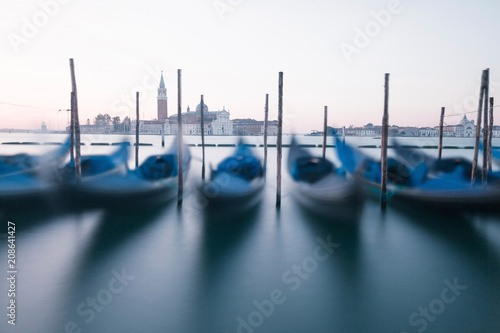 Venice traditional gondolas on the waves