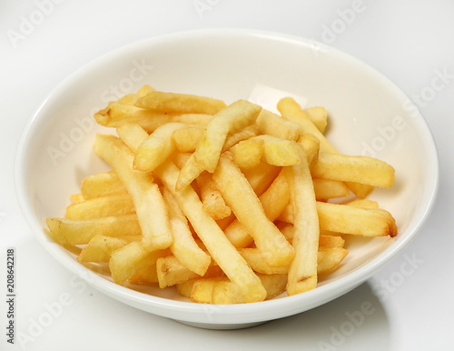 Garnish of french fries in a white plate on a white background