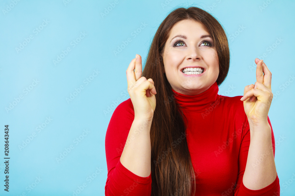Fototapeta premium Woman keeping her fingers crossed