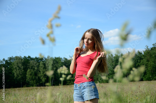 Valokuva Woman with jeans shorts in the meadow
