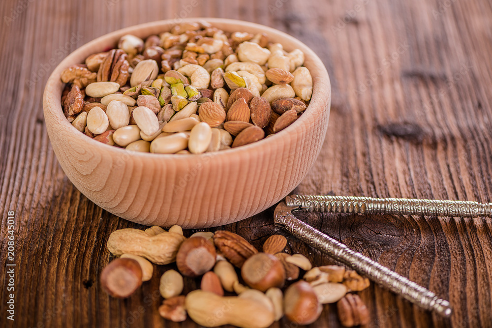 wooden bowl full of different muxture variety of nuts wooden bowl full of different muxture variety of nuts