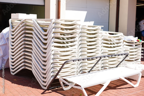 Beach chaise lounges stacked in a row