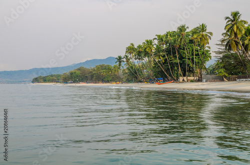 Calm water, palm trees and white sand beach at Tokeh Beach, south of Freetown, Sierra Leone, Africa