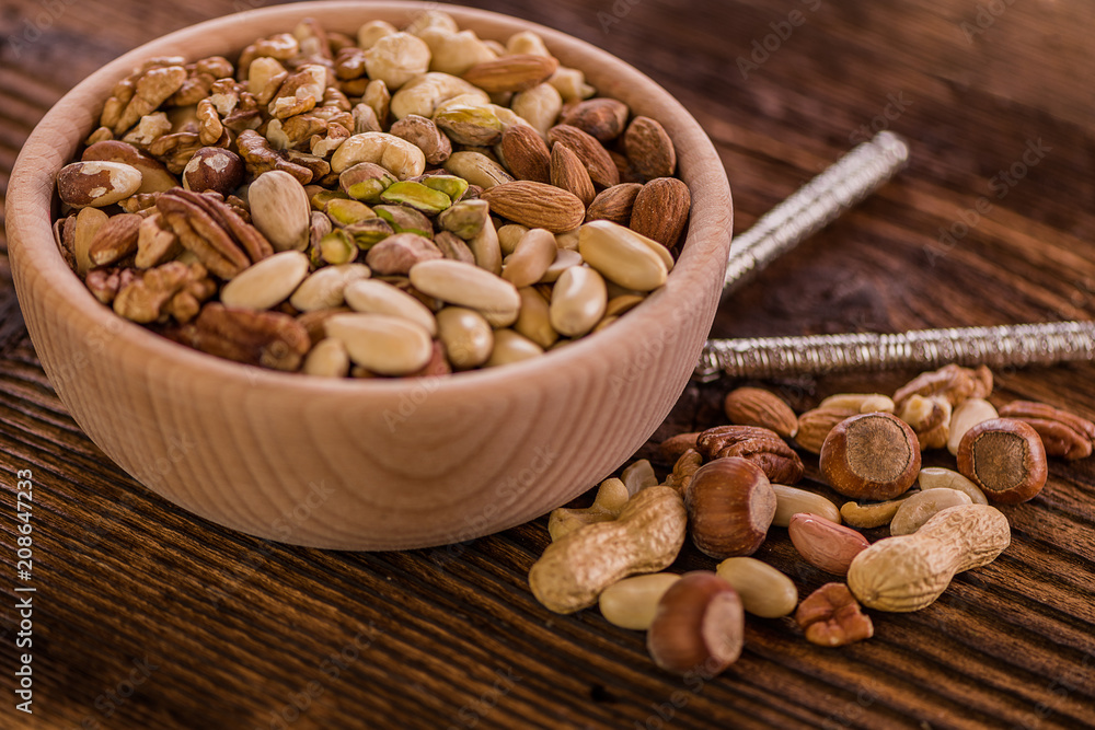wooden bowl full of different muxture variety of nuts 