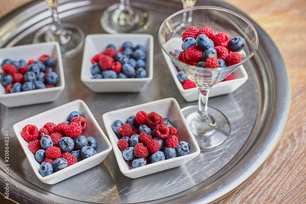 Berries of blueberries, raspberries in a beautiful vase on the table Berries of blueberries, raspberries in a beautiful vase on the table
