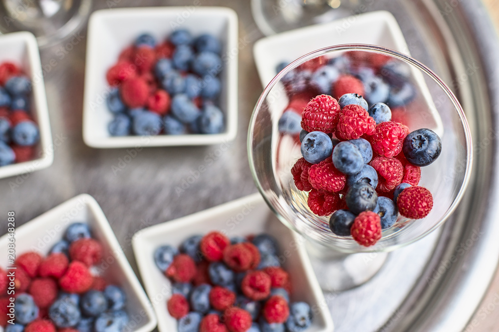 Berries of blueberries, raspberries in a beautiful vase on the table Berries of blueberries, raspberries in a beautiful vase on the table