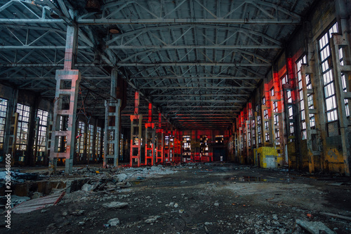 Large industrial hall illuminated by red lights. Abandoned Voronezh excavator plant