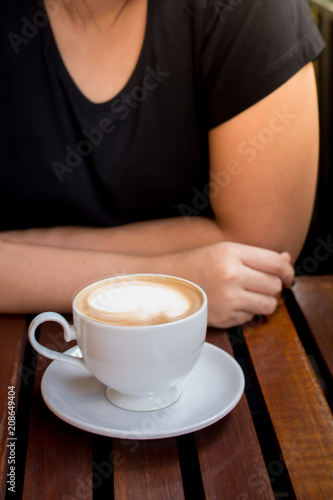 girl with hot coffee on the wooden table
