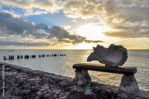 Stone Seashell in front of a Beach sunset at Holbox Island, Mexico photo