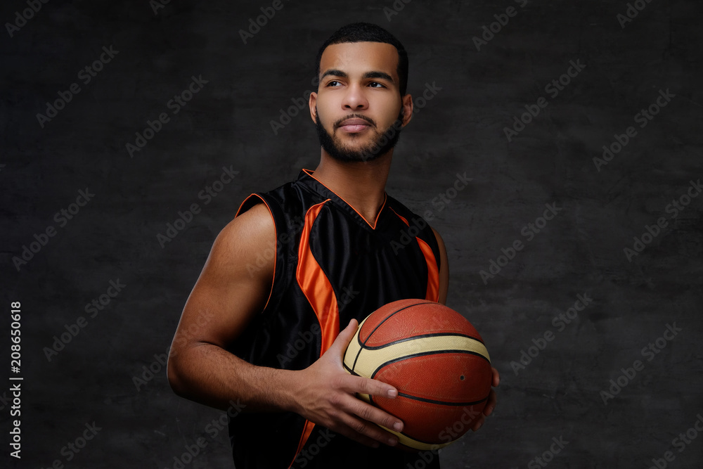 Portrait of an Afro-American sportsman. Basketball player in sportswear with a ball Portrait of an Afro-American sportsman. Basketball player in sportswear with a ball