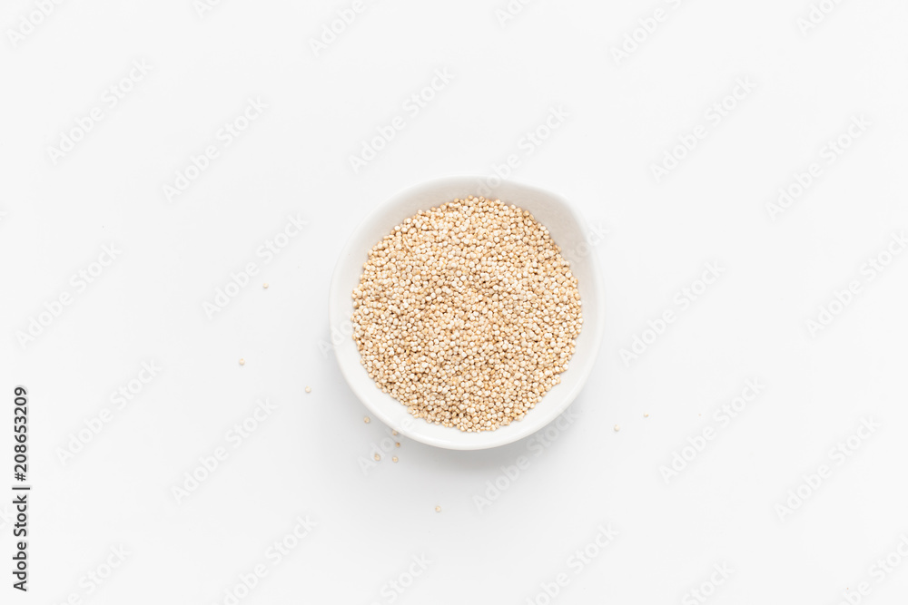 Quinoa in white bowl on white background. Copy space text Quinoa in white bowl on white background. Copy space text