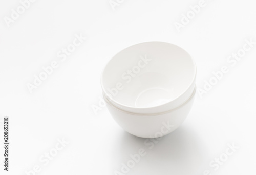 Pair of white bowls on white background.  Copy space text