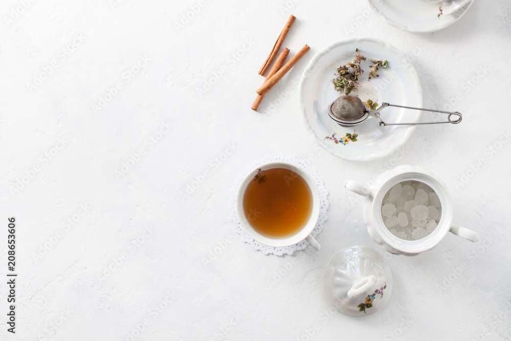 Tea in a Cup with dry flowers on a white table. Copy space text Tea in a Cup with dry flowers on a white table. Copy space text