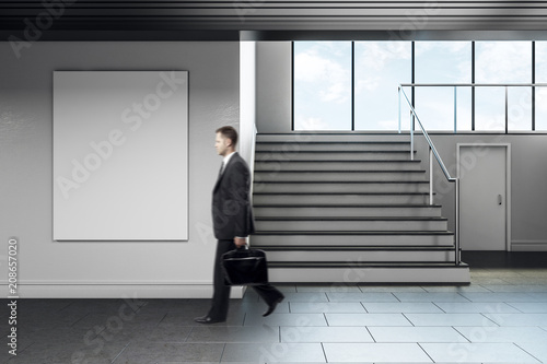 Businessman walking in modern school corridor