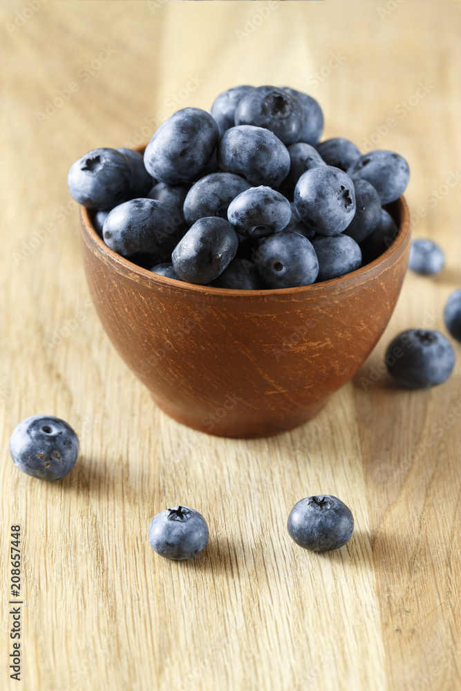 ripe organic bog whortleberry in a wooden plate ripe organic bog whortleberry in a wooden plate