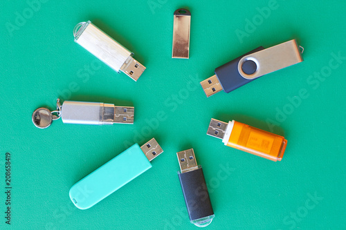 A lot of usb flash drive lie on the table.