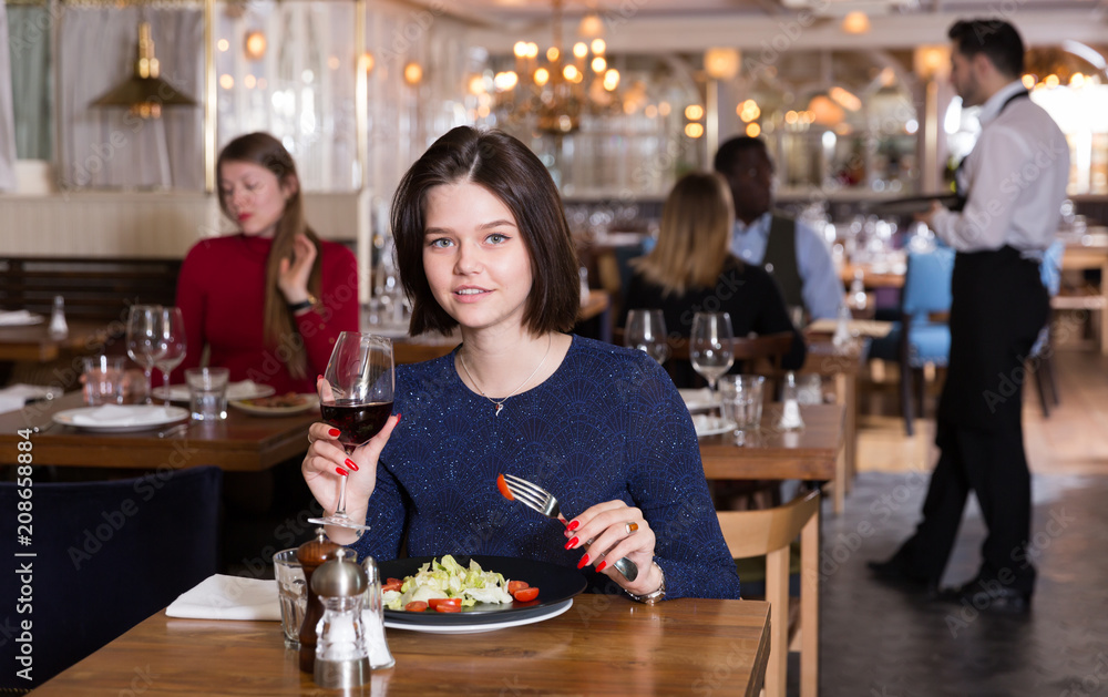 Woman enjoying dinner alone in restaurant