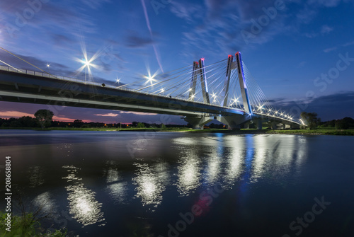 modern bridge over Vistula river, Krakow, Poland, illuminated in the night