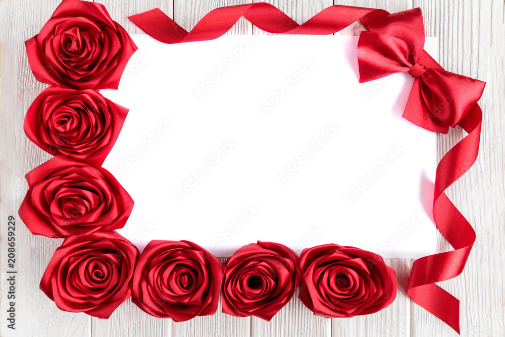 Blank white greeting card with red roses flowers and red ribbon bow on  rustic wooden background. Top view. Valentines day or women's day. Stock  Photo | Adobe Stock