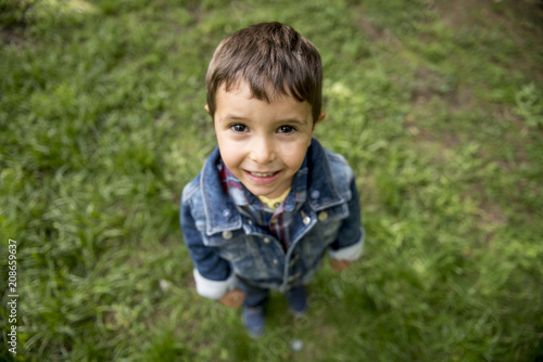 Handsome little boy posing in the park