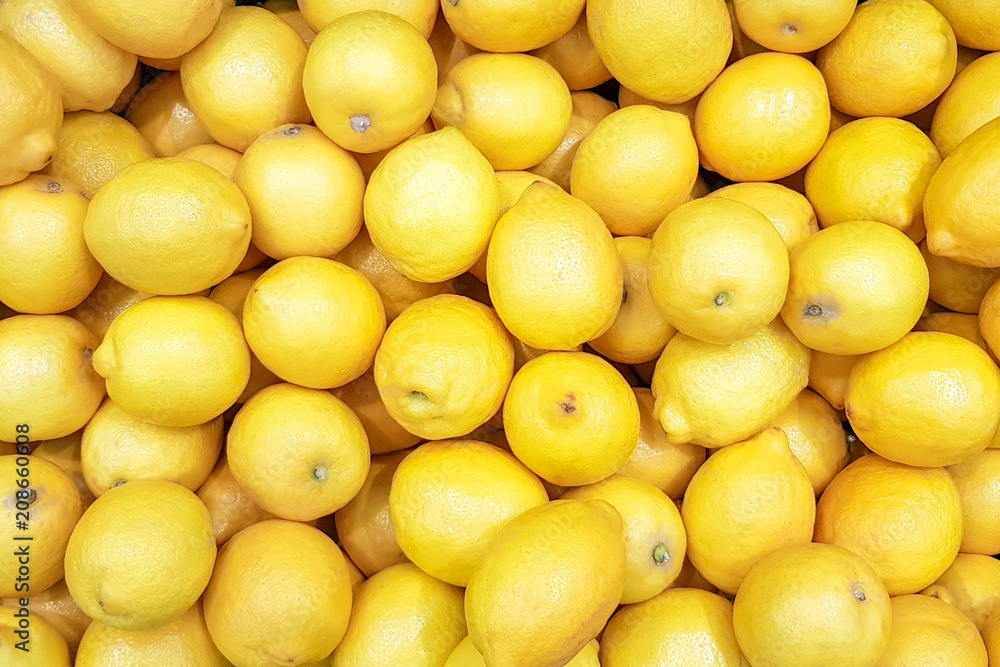 A pile of lemons in a market (background) A pile of lemons in a market (background)