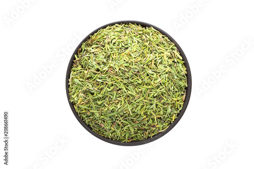 dried thyme in clay bowl isolated on white background. Seasoning or spice top view