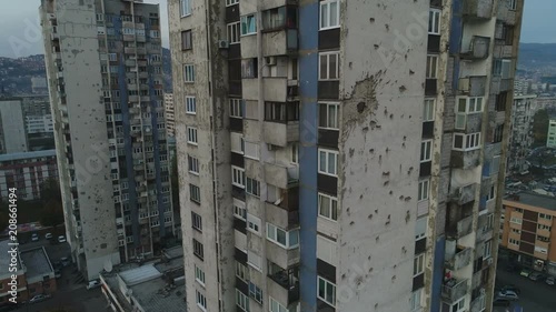 Drone shot of Soviet style residential apartment building, heavily damaged during the Bosnian war and Siege of Sarajevo photo