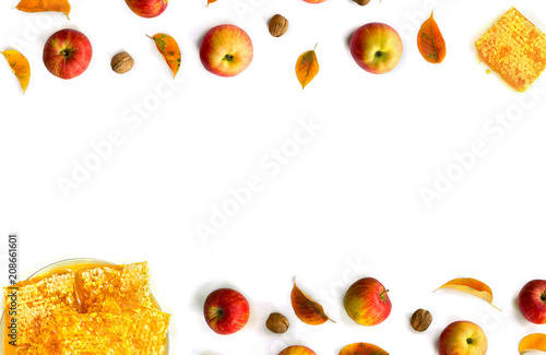 Fototapeta Naklejka Na Ścianę i Meble -  Ripe yellow red juicy apples with leaves, honey, honeycombs and walnuts autumn on white background with space for text. Top view, flat lay